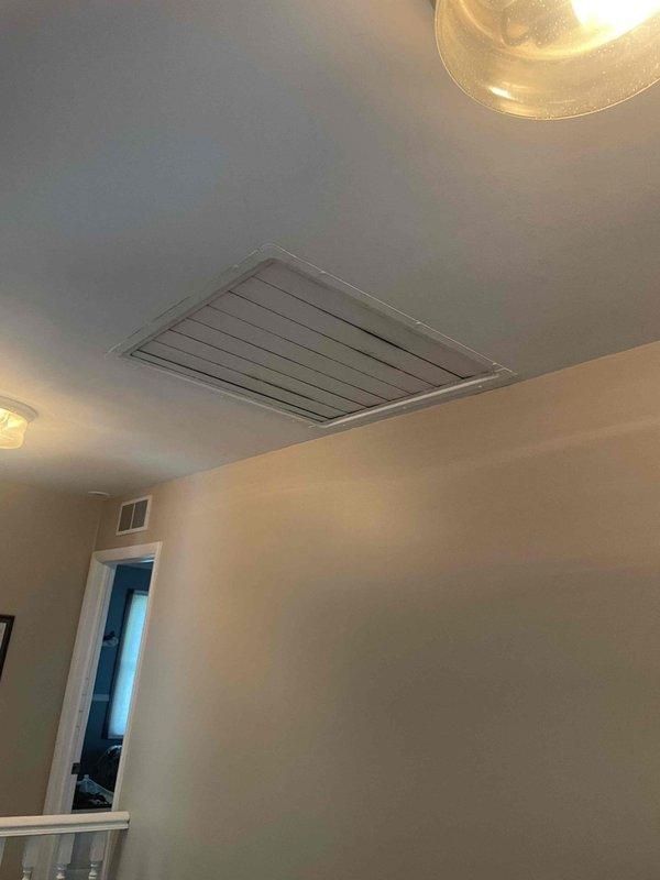 Responded to service call for non-functional air conditioning system with no cooling capability. Upon arrival, evaluated 10-year-old exterior AC unit and assessed overall system condition. Conducted comprehensive inspection of outdoor condensing unit and interior air handling components, including examination of attic access points and ceiling-mounted ventilation grilles to determine system layout and accessibility. Documented equipment age, location, and current operational status through photographic documentation of interior HVAC infrastructure. Provided detailed replacement estimate for complete system upgrade due to unit age and failure to provide adequate cooling.