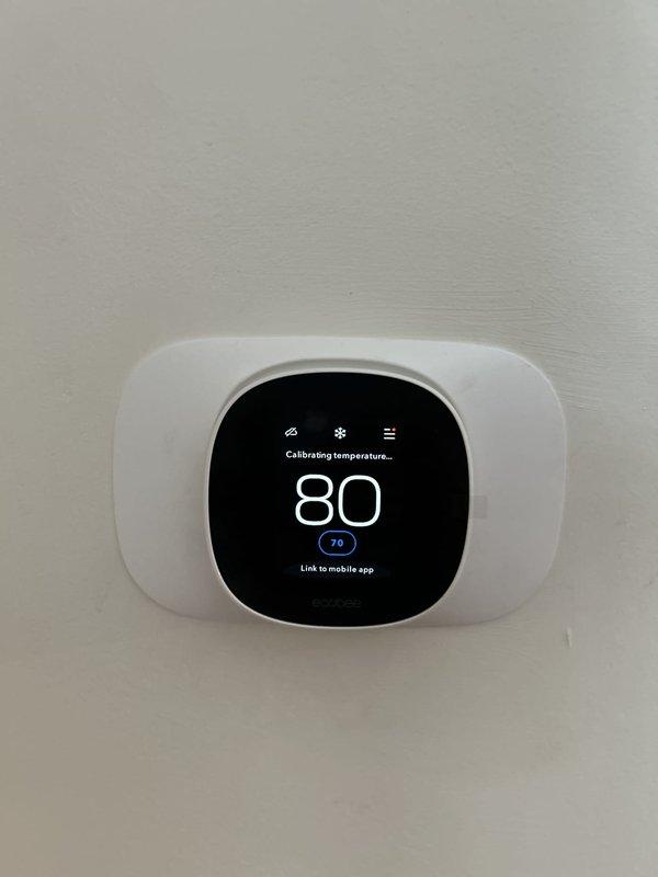 Completed full HVAC system installation including a 90,000 BTU furnace and 3-ton air conditioning unit in rear yard location. Installed Ecobee 3 Lite smart thermostat with calibration and mobile app connectivity, added humidifier, and reconnected existing electrical service. Coordinated electrical panel work with licensed electrician to ensure proper circuit breaker installation and load distribution for new equipment, obtained mechanical and electrical permits, and submitted documentation for utility rebate program with AHRI certification number on file.