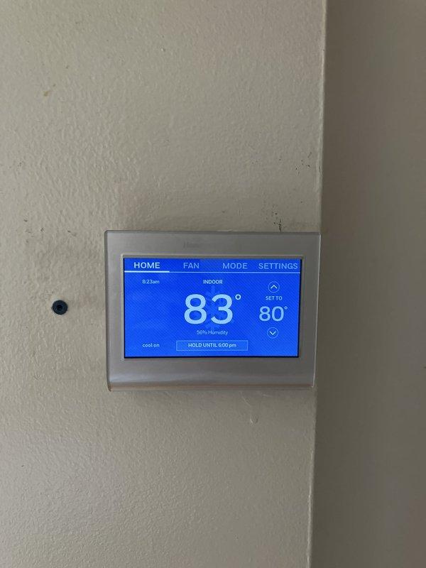Completed comprehensive estimate for full HVAC system replacement on 20+ year old equipment located in basement, including evaluation of outdoor condensing unit and indoor components. Assessment included electrical panel upgrade requirements to support new system installation. Documented existing thermostat configuration, outdoor unit placement on concrete pad against brick exterior, and electrical connections requiring modification for updated equipment.