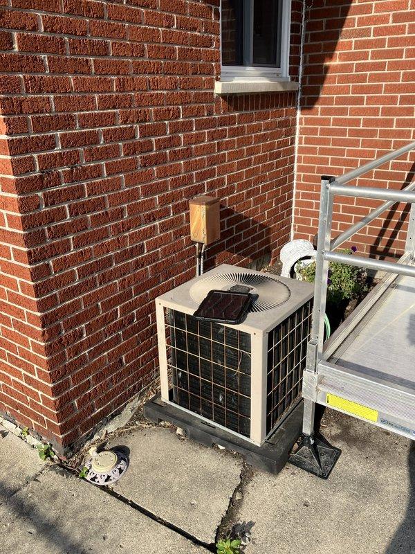 Completed comprehensive estimate for full HVAC system replacement on 20+ year old equipment located in basement, including evaluation of outdoor condensing unit and indoor components. Assessment included electrical panel upgrade requirements to support new system installation. Documented existing thermostat configuration, outdoor unit placement on concrete pad against brick exterior, and electrical connections requiring modification for updated equipment.