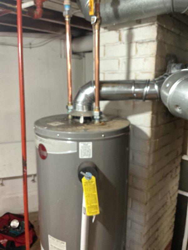Performed tanked water heater installation in basement mechanical room. Unit was properly positioned, copper supply lines were connected to the top of the tank with shutoff valves installed, and all connections were secured according to plumbing code requirements. Documentation tags were attached to the unit for future reference.