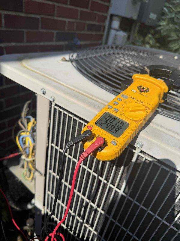 Responded to no cooling complaint on 15-year-old residential air conditioning system located in basement. Upon arrival, confirmed unit was running but producing loud operational noises from outdoor condenser. Performed visual inspection of outdoor condenser unit positioned against exterior brick wall, noting unit appeared structurally intact with no visible external damage to cabinet or coil fins. Conducted electrical diagnostics using digital multimeter to test voltage and amperage at condenser unit. Measured supply voltage and compressor amp draw to determine if compressor was operating within manufacturer specifications. Based on age of equipment and diagnostic findings, identified failing compressor as source of excessive noise and reduced cooling capacity. Advised homeowner of repair options and recommended system replacement due to age and cost-effectiveness of repairs versus new installation. Unit remains operational but requires further action to restore proper cooling function