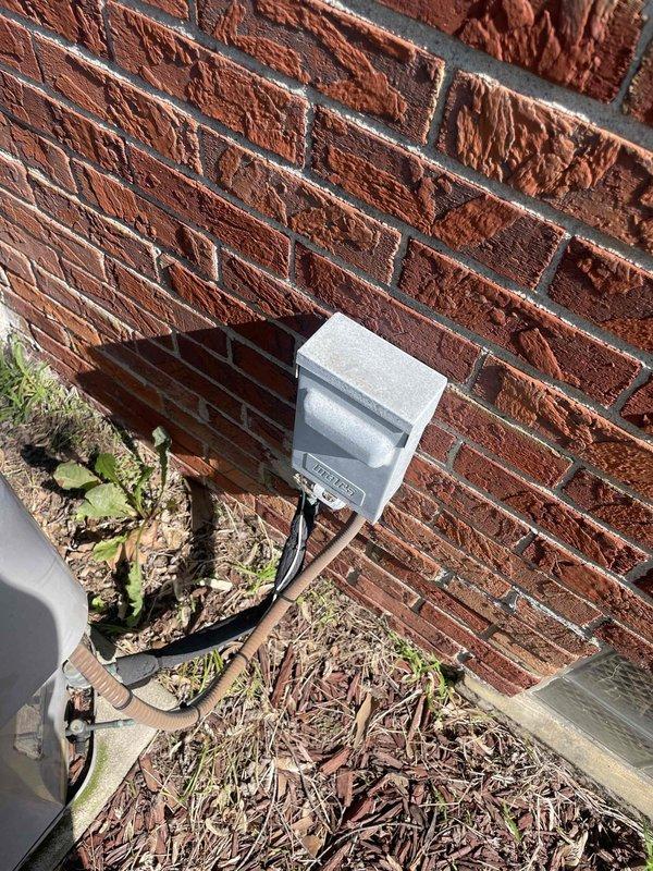 Provided comprehensive estimate for complete central air conditioning system replacement at owner-occupied residence. Existing outdoor condenser unit, approximately 20 years old and located in backyard against brick exterior wall, has reached end of serviceable life. Unit assessed and documented with photographic records showing round-top condenser with radial fin pattern positioned on concrete pad with electrical disconnect box mounted on wall above. Presented replacement options for new energy-efficient central AC system to restore reliable cooling capacity.