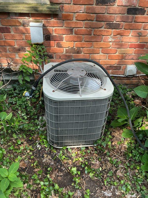 Completed comprehensive biannual Gold AC maintenance inspection on a 12-year-old air conditioning system. Performed standard cooling system tune-up including inspection of outdoor condensing unit, verified proper operation of all components, checked refrigerant levels, cleaned coils, and tested system performance. Noted vegetation growth around outdoor unit base and recommended clearance maintenance for optimal airflow and efficiency. Both AC systems inspected and confirmed operational with no immediate repairs required. All safety checks passed and system operating within normal parameters.