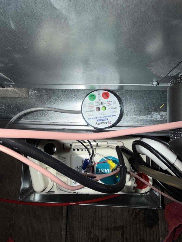 Responded to warranty call for condensation leak from air handler located in attic. Unit is approximately 2-3 months old. Upon inspection, observed moisture accumulation within air handler cabinet and on interior surfaces. Verified condensate drain line for proper pitch and clearance. Checked drain pan for cracks or improper installation. Inspected evaporator coil and cabinet insulation for gaps that could allow warm air infiltration causing excessive condensation. Reviewed Asurity monitoring system readings to verify system operation and airflow parameters. Confirmed thermostat set to 80°F cooling mode with ecobee smart thermostat functioning properly. Identified issue with condensate drainage system and addressed blockage/improper installation causing water accumulation. Cleared drain line and verified proper flow. Tested system operation through complete cooling cycle to ensure condensation draining correctly. No further leakage observed. System operating within manufacturer specifi