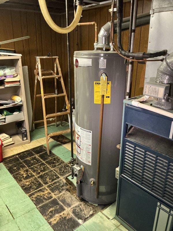 Responded to service call for leaking residential water heater in basement utility area. Upon inspection, confirmed Bradford White tanked water heater was leaking from bottom of unit, indicating internal tank failure. Disconnected existing water supply lines, drain valve, and gas connections. Removed failed unit and installed new Bradford White residential gas-fired water heater. Connected copper supply piping, installed code-compliant temperature and pressure relief valve with proper discharge piping, and reconnected gas line with new flexible connector. Attached vent pipe to existing exhaust system, verified proper draft, and tested all connections for leaks. Filled tank, purged air from system, lit pilot light, and verified proper burner operation and temperature settings. Conducted final inspection of all plumbing connections and gas fittings to ensure leak-free installation. Unit tested and operating within manufacturer specifications upon completion.
