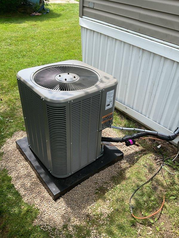 Successfully completed installation of a 2-ton air conditioning system with evaporator coil for a mobile home application. The outdoor condenser unit was positioned on a concrete pad with proper mounting and vibration isolation, while the indoor coil was integrated with the existing furnace system. All refrigerant lines were connected and secured, electrical connections were completed, and the system was tested for proper operation. Required permits were obtained prior to installation, and all work was performed in accordance with manufacturer specifications and local building codes.