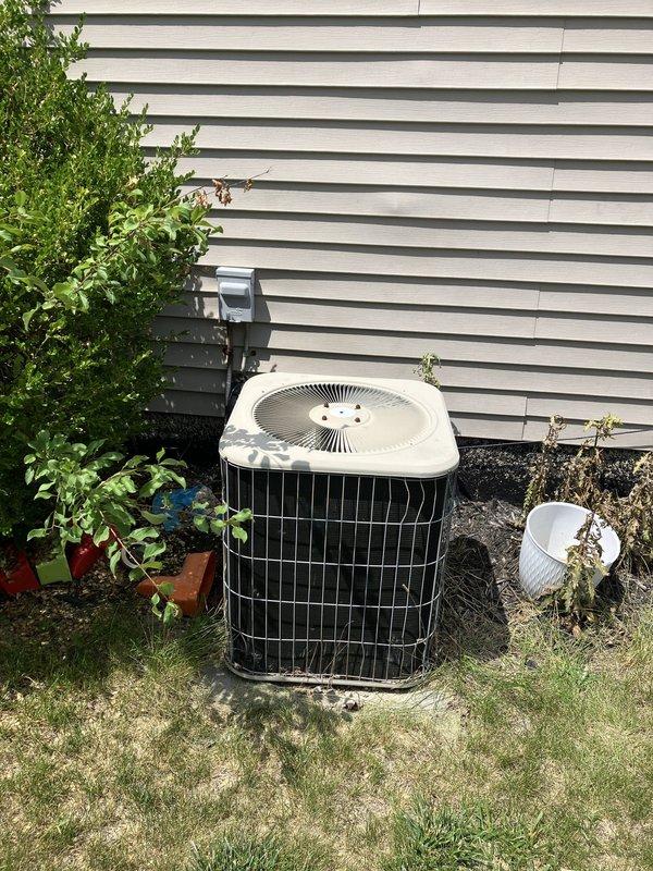 Responded to service call for air conditioning system not producing cold air and failing to maintain temperature. Upon inspection, found 20+ year old AC system with outdoor condenser unit and basement-located air handler had exceeded its operational lifespan. Evaluated complete HVAC system including existing furnace equipment as requested. Documented current equipment configuration with outdoor condensing unit positioned on exterior wall and indoor components located in basement mechanical room with existing ductwork infrastructure. Provided comprehensive replacement estimate for new air conditioning system and discussed furnace replacement options to address aging equipment concerns.