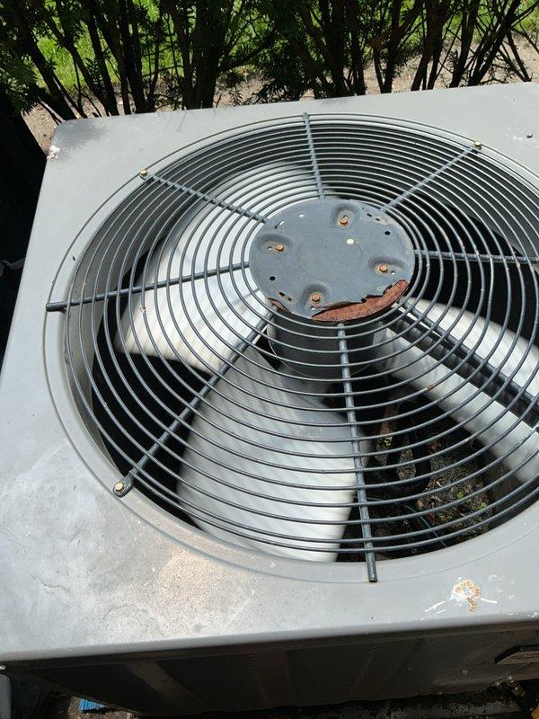 Completed comprehensive Gold AC Inspection on residential property with three HVAC units of varying ages (2011, 2013, and 2020 models). Performed thorough visual assessment of outdoor condenser units, noting weathering consistent with outdoor exposure and minor rust formation on mounting brackets. Inspected fan assemblies, protective grilles, and housing integrity across all units. Evaluated air handler and coil equipment located in basement area. All systems confirmed operational at time of inspection. Documented equipment condition through photographic records showing condenser placement, ventilation clearances, and overall unit status for maintenance history records.