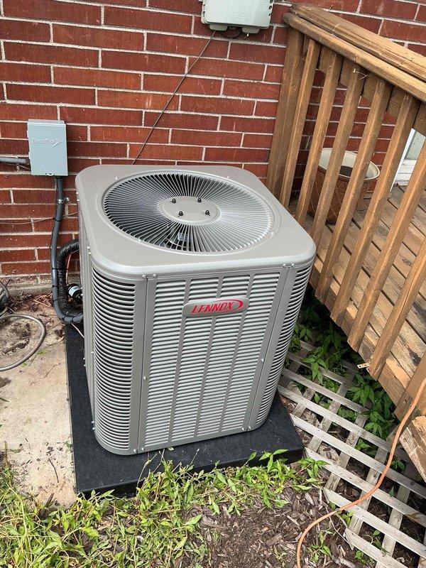 Completed installation of 2-ton Lennox air conditioning system with matching evaporator coil. Outdoor condensing unit positioned in rear yard on composite pad against exterior brick wall with electrical disconnect and proper conduit routing. Indoor evaporator coil installed atop existing air handler with copper refrigerant line connections, proper insulation, and condensate drainage. System reconnected, tested for proper operation, and left running efficiently. All mechanical and electrical permits obtained per local requirements.