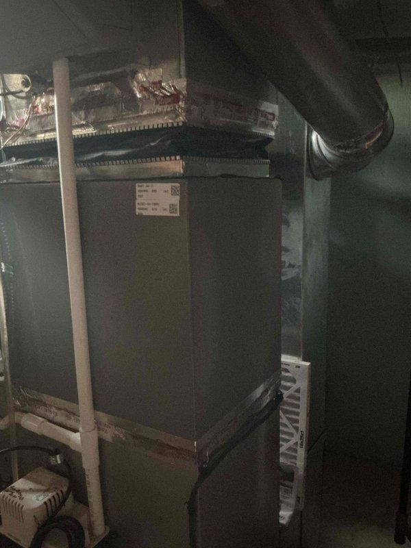 Completed installation of 2-ton Lennox air conditioning system with matching evaporator coil. Outdoor condensing unit positioned in rear yard on composite pad against exterior brick wall with electrical disconnect and proper conduit routing. Indoor evaporator coil installed atop existing air handler with copper refrigerant line connections, proper insulation, and condensate drainage. System reconnected, tested for proper operation, and left running efficiently. All mechanical and electrical permits obtained per local requirements.