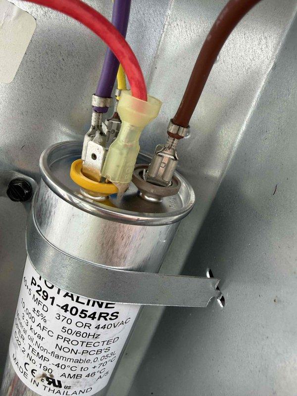 Responded to no cooling complaint on 7-year-old residential air conditioning system. Upon arrival, found outdoor condensing unit inoperative. Performed diagnostic testing and identified failed dual run capacitor preventing compressor and condenser fan motor operation. Verified capacitor failure using digital multimeter, reading zero microfarads on affected terminals. Replaced defective Aqualine FB291-405RU2 capacitor with new OEM-equivalent component rated at 370/440VAC. Restored power to unit and confirmed proper compressor startup, condenser fan operation, and normal system pressures. Tested system through complete cooling cycle with all components functioning within manufacturer specifications. System returned to full operational status with proper cooling restored.