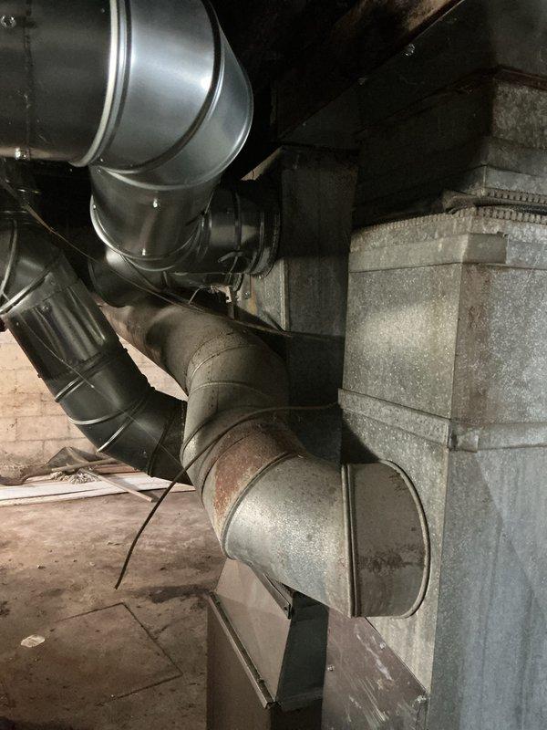 Conducted comprehensive assessment of basement HVAC system for air conditioning replacement estimate. Evaluated existing ductwork configuration, including galvanized steel and flexible ducting sections with multiple transitions and elbow joints showing age-related wear and dust accumulation. Documented current Honeywell thermostat set at 85 degrees and reviewed system layout to determine optimal replacement equipment specifications and installation requirements.