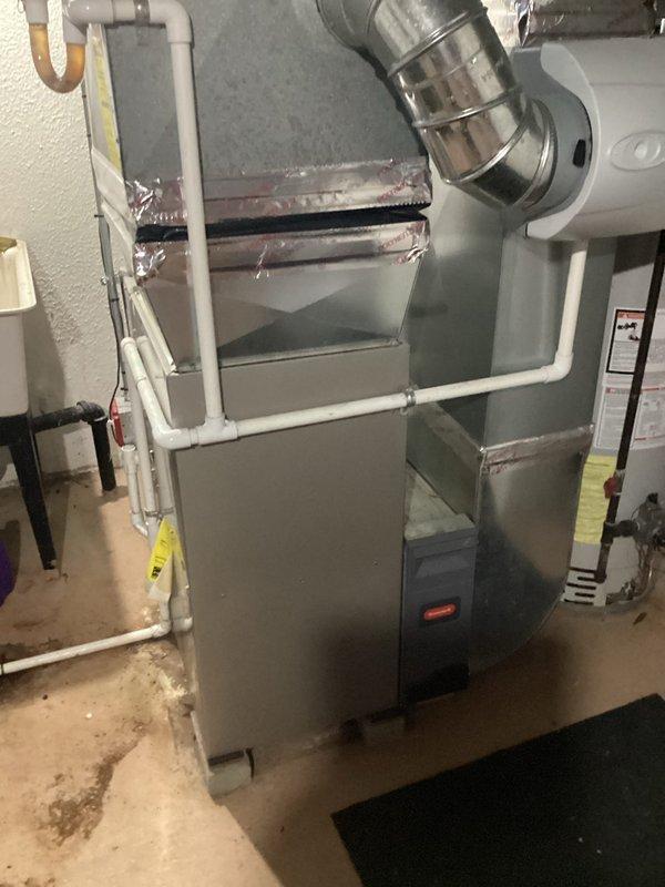 Responded to service call for central air conditioning system failing to adequately cool residence despite airflow from vents and operational outdoor condenser fan. Conducted comprehensive system evaluation of existing York brand outdoor condenser unit and indoor furnace/air handler assembly with connected ductwork. Documented current equipment configuration including basement-installed gray metal furnace with metallic supply ductwork, PVC condensate drainage, and refrigerant line sets. Assessed outdoor condenser unit condition, fan motor operation, and electrical connections. Provided detailed replacement estimate for complete HVAC system upgrade due to insufficient cooling capacity and aging equipment performance issues.