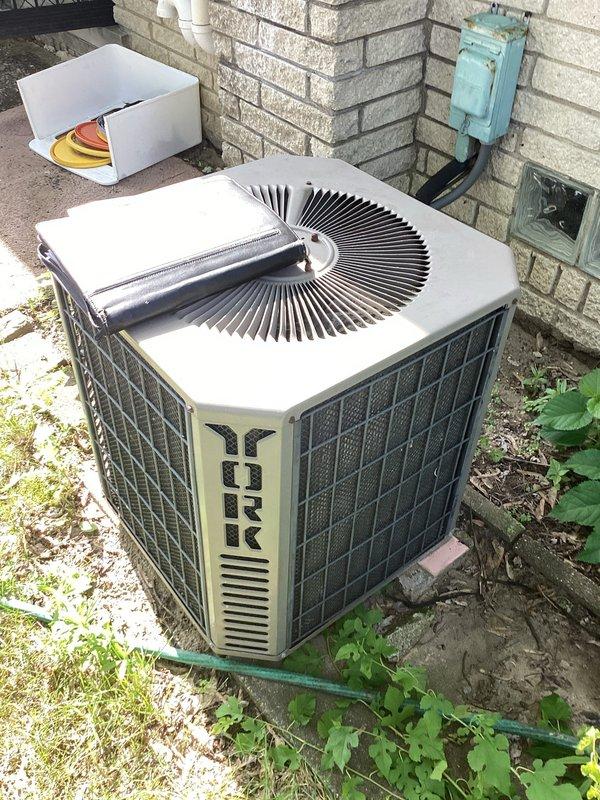 Responded to service call for central air conditioning system failing to adequately cool residence despite airflow from vents and operational outdoor condenser fan. Conducted comprehensive system evaluation of existing York brand outdoor condenser unit and indoor furnace/air handler assembly with connected ductwork. Documented current equipment configuration including basement-installed gray metal furnace with metallic supply ductwork, PVC condensate drainage, and refrigerant line sets. Assessed outdoor condenser unit condition, fan motor operation, and electrical connections. Provided detailed replacement estimate for complete HVAC system upgrade due to insufficient cooling capacity and aging equipment performance issues.