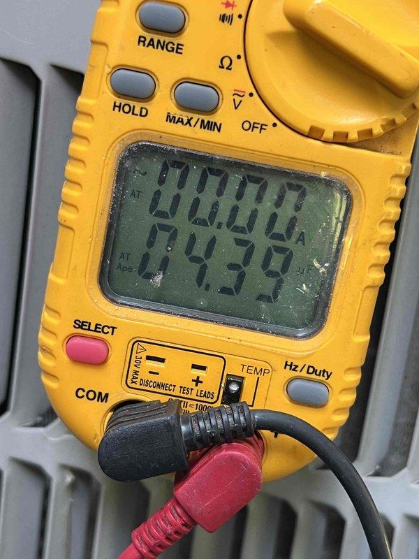 Completed comprehensive Gold AC inspection on 10+ year old residential air conditioning system with basement-located air handler. Performed detailed evaluation of 123ANA036-C unit (S/N 2614E14715), a 3-ton R410A system rated at 208-230V. Conducted electrical diagnostics using digital multimeter to verify proper voltage and amperage readings, confirming system operating within manufacturer specifications. Inspected condenser unit exterior condition, verified nameplate data legibility, and documented equipment specifications. Unit currently operational with no immediate concerns identified. Captured photographic documentation of equipment nameplate and diagnostic measurements for service records.