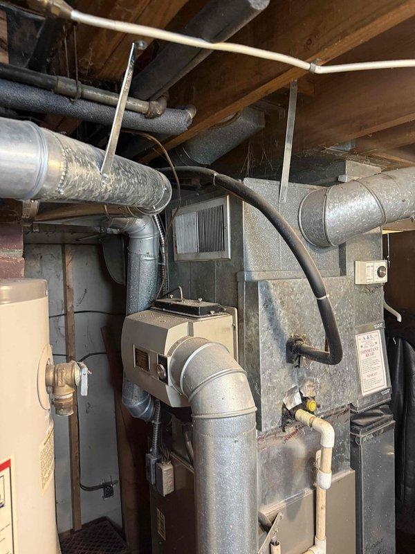 Performed comprehensive second opinion evaluation on non-operational 2003 HVAC system after customer received replacement recommendations from two previous contractors. Conducted thorough diagnostic inspection of furnace and air conditioning components, including visual assessment of air handler, ductwork connections, electrical controls, and mechanical systems. Examined condition of existing equipment installation, ductwork integrity, and overall system infrastructure in basement mechanical room. Documented equipment age, configuration, and current operational status through detailed photographic evidence for customer records and recommendation development.