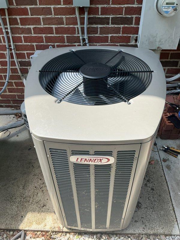 Completed comprehensive Gold AC inspection on two residential HVAC units, both approximately 5 years old. Performed thorough examination of outdoor Lennox condenser unit and secondary system, both mounted on concrete pads against exterior brick wall. Inspected condenser cabinets, top-discharge fan assemblies, protective grilles, and ventilation louvers for proper operation and physical condition. Verified refrigerant line connections, electrical conduit, and associated piping. Checked concrete pad stability and unit levelness. Both systems operating normally with no deficiencies noted. Provided complimentary air filter as part of Gold maintenance package. Equipment shows appropriate wear for age with functional components in good working order.
