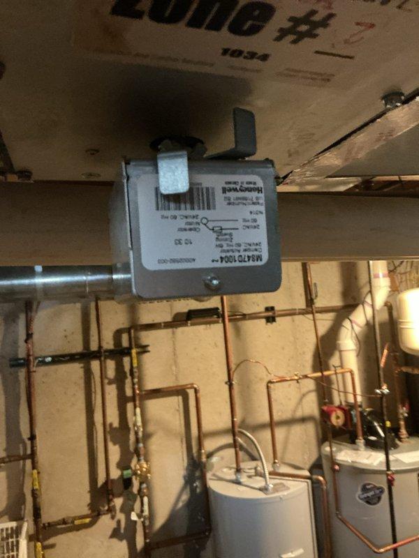 Responded to no cooling complaint on 5-year-old zoned AC system located in basement. Upon inspection, diagnosed failed zone motor actuators preventing proper damper operation in multiple zones. Zone motors were previously ordered under existing purchase order. Replaced defective Honeywell zone actuators on copper piping manifold system, verified proper damper movement, and tested all zones for correct operation. System restored to full cooling capacity with all zones functioning properly.