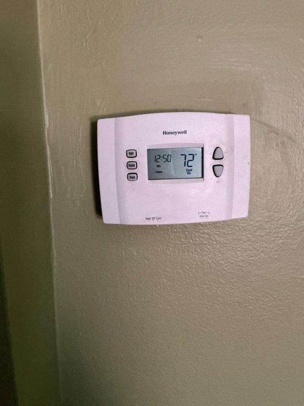 Completed comprehensive Gold AC Inspection on single residential cooling system with Bryant furnace installation. Verified thermostat operation showing proper temperature control at 72°F with programmable Honeywell unit functioning correctly. Inspected equipment in basement utility area, confirmed system operational status, documented HVAC components including furnace unit with proper PVC venting configuration and gas connections secure.