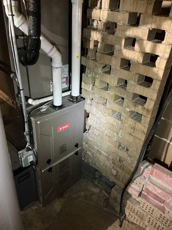 Completed comprehensive Gold AC Inspection on single residential cooling system with Bryant furnace installation. Verified thermostat operation showing proper temperature control at 72°F with programmable Honeywell unit functioning correctly. Inspected equipment in basement utility area, confirmed system operational status, documented HVAC components including furnace unit with proper PVC venting configuration and gas connections secure.
