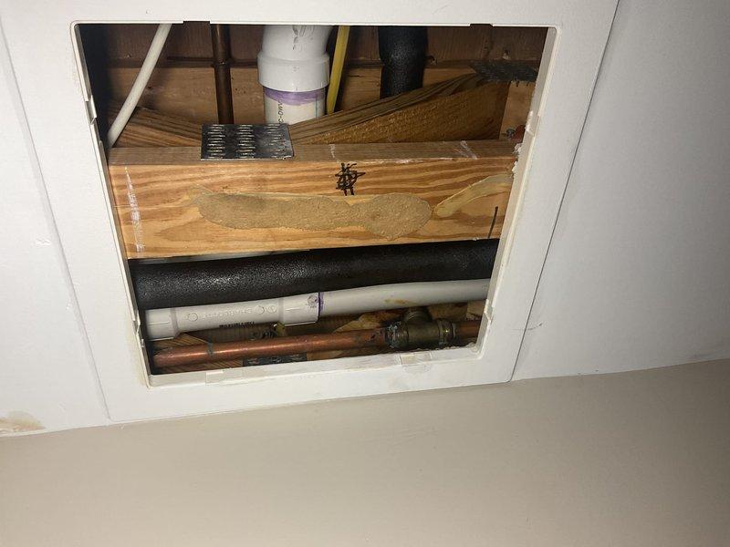 Responded to water leak originating from a leaking valve in the ceiling space above finished area. Upon arrival, accessed ceiling cavity and inspected plumbing infrastructure, including copper supply lines, PVC drainage piping, and associated fittings. Documented existing conditions showing aged copper piping with visible corrosion and patina, along with brass threaded connections displaying oxidation. Water was not shut off at time of inspection per coordination with HVAC contractor regarding valve isolation.