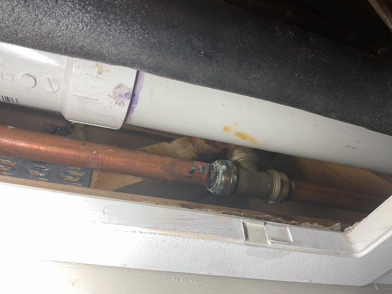 Responded to water leak originating from a leaking valve in the ceiling space above finished area. Upon arrival, accessed ceiling cavity and inspected plumbing infrastructure, including copper supply lines, PVC drainage piping, and associated fittings. Documented existing conditions showing aged copper piping with visible corrosion and patina, along with brass threaded connections displaying oxidation. Water was not shut off at time of inspection per coordination with HVAC contractor regarding valve isolation.