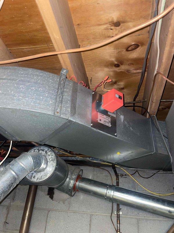Completed comprehensive HVAC system evaluation for residential property with 10+ year old R22 equipment experiencing low refrigerant charge. Inspected basement-mounted vertical furnace with connected air handler, ductwork, and electrical components, as well as attic-installed evaporator coil with associated refrigerant lines and control systems. Documented existing system configuration including galvanized metal ductwork, flexible duct connections, copper refrigerant piping, electrical panels, and drainage components to provide detailed replacement estimate for outdated R22 system.