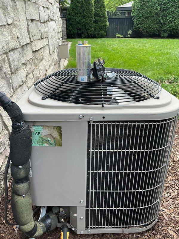 Responded to no cooling complaint on 2018 residential AC system located upstairs. Upon arrival, inspected outdoor condenser unit and found system not operating. Diagnosed failed capacitor preventing compressor and condenser fan motor from starting. Replaced defective dual run capacitor with manufacturer-approved replacement, verified proper microfarad ratings, and tested system operation. Confirmed compressor engaged properly, condenser fan motor running at correct speed, and unit cooling effectively. System restored to normal operation.