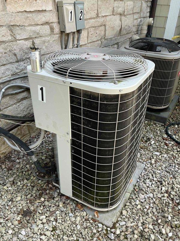 Responded to no cooling complaint on 2018 residential AC system located upstairs. Upon arrival, inspected outdoor condenser unit and found system not operating. Diagnosed failed capacitor preventing compressor and condenser fan motor from starting. Replaced defective dual run capacitor with manufacturer-approved replacement, verified proper microfarad ratings, and tested system operation. Confirmed compressor engaged properly, condenser fan motor running at correct speed, and unit cooling effectively. System restored to normal operation.