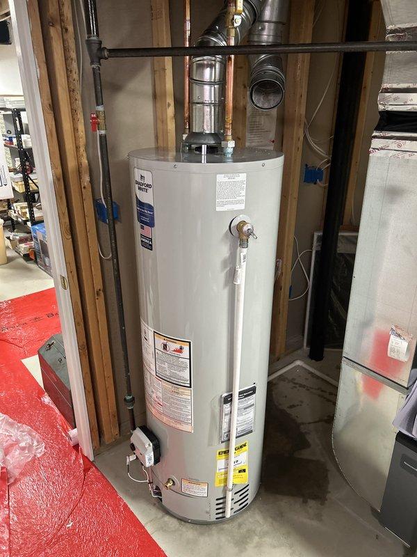 Completed installation of 90,000 BTU high-efficiency furnace and 40-gallon standard water heater in residential basement. Reconnected existing humidifier to new furnace system, installed proper venting and flue piping for both units, and verified all gas connections, electrical hookups, and safety controls were functioning correctly. Mechanical permit was requested and all work was performed to code specifications, with final system testing confirming proper operation of heating equipment and domestic hot water supply.