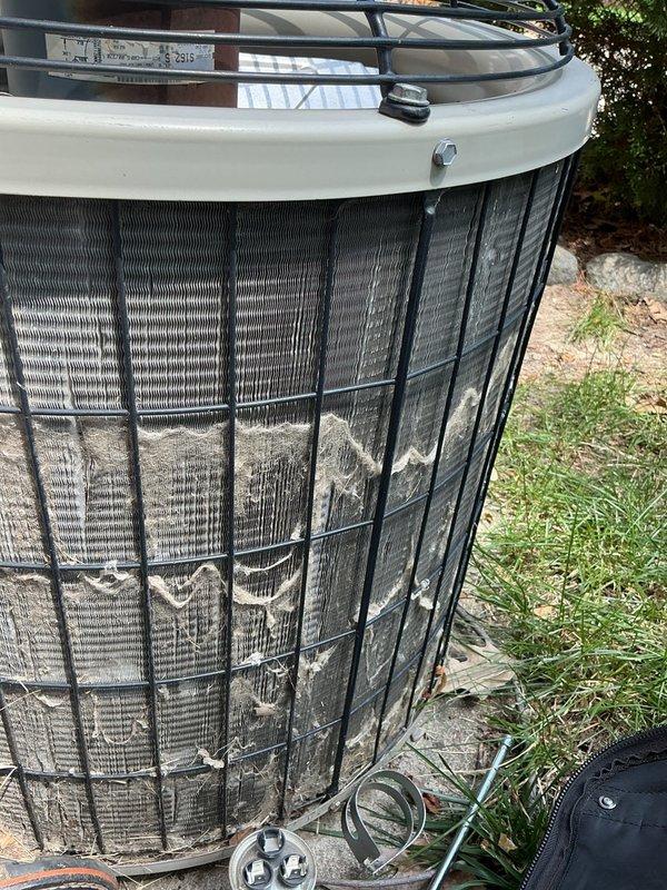 Responded to no cooling call on residential air conditioning system. Upon inspection, found failed dual-run capacitor with visible terminal discoloration and tarnishing, preventing compressor and condenser fan motor operation. Replaced defective capacitor with new unit matching proper microfarad and voltage specifications. Additionally observed heavily soiled condenser coil with significant dirt and debris accumulation restricting airflow through fins. System restored to normal cooling operation and tested for proper function.