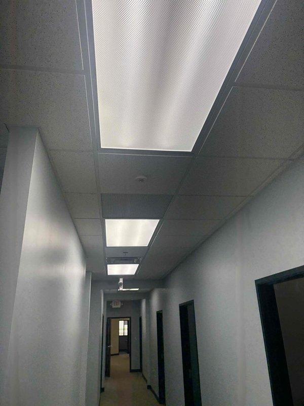 Completed commercial electrical outlet installation and verification in office building. Inspected and documented existing 120/208V electrical panel system with multiple circuit breakers, confirmed proper labeling and safety signage in place. Installed new outlets per specifications and performed comprehensive testing to ensure all receptacles were properly grounded, functioning correctly, and met code requirements throughout the hallway and adjacent office spaces.