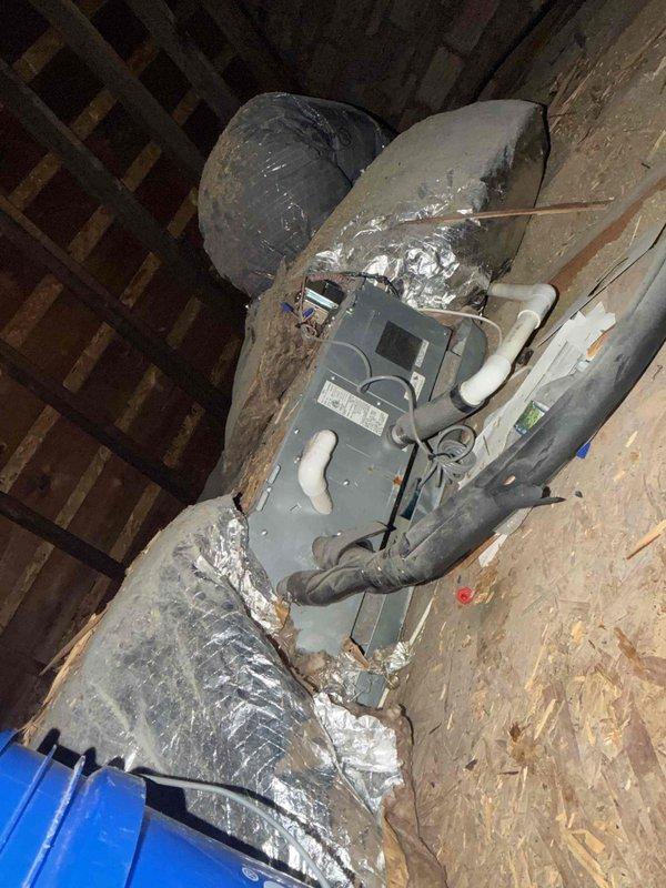 Responded to no cooling complaint on attic-installed mini split system of unknown age. Upon inspection, utilized Fieldpiece SMAN manifold gauge to diagnose R-410A refrigerant system, recording operating pressures of 664 PSIG on high side and 0.0 PSIG on low side, with superheat reading of 71.1°F and saturated suction temperature of 125°F. Diagnostic readings indicated complete loss of refrigerant charge on low pressure side, confirming system was unable to operate due to insufficient refrigerant. Inspected ductwork and condensate drainage system in attic installation, noting dust accumulation on flex ducts and general aging of insulation material. System requires refrigerant leak detection, repair of leak source, evacuation, and proper recharge to restore cooling operation.