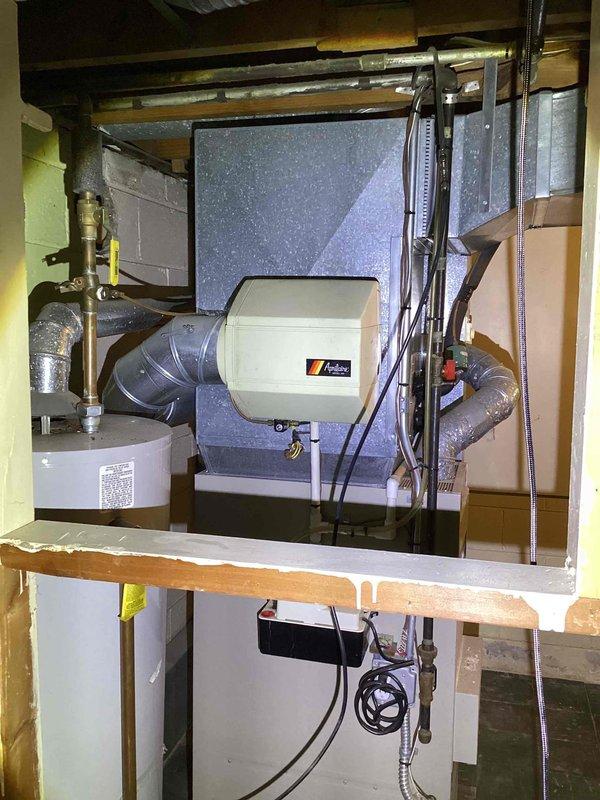 Conducted comprehensive assessment of existing HVAC system including aging furnace, air conditioning unit, and current humidifier installation in basement. Evaluated second-floor attic space with knotty pine paneling and drop ceiling for potential ductless mini-split installation to address heating and cooling needs in upper level. Documented existing equipment configuration, ductwork layout, electrical connections, and structural considerations to provide accurate full system replacement estimate including main floor equipment upgrade and supplemental mini-split system for second floor.