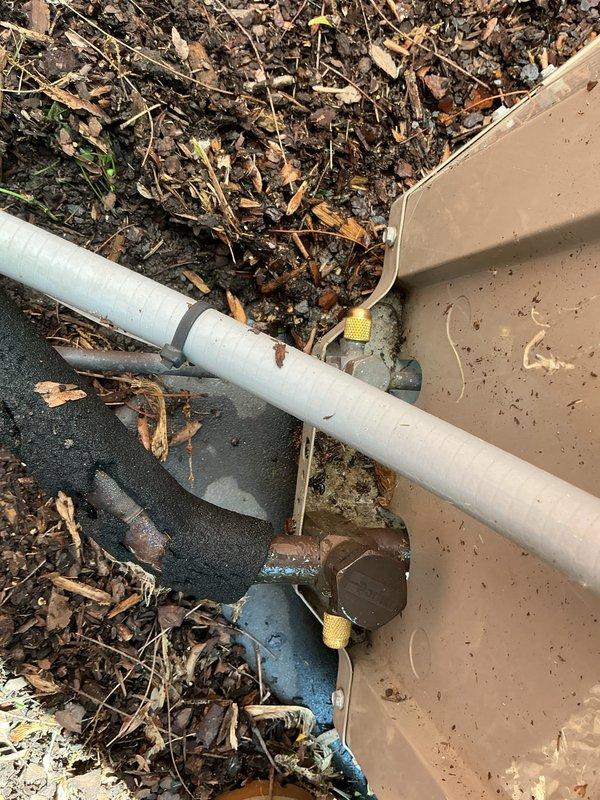 Completed comprehensive Gold-level air conditioning inspection on a 13-year-old residential cooling system with basement-mounted evaporator coil. Performed full system evaluation including exterior disconnect inspection, condensate drain line assessment, and exterior condenser unit examination. All equipment found operational at time of service. Documented system conditions with photographic records of electrical disconnect box mounted on exterior brick wall and condensate drain piping assembly with shutoff valve. System components showed normal weathering consistent with age but remain functional. No immediate repairs required at this time.