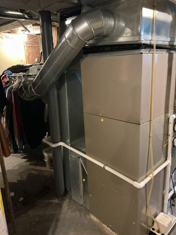Completed comprehensive Gold AC Inspection on 11-year-old residential HVAC system located in basement mechanical room. Performed thorough visual examination of furnace unit, ductwork connections, electrical wiring, and associated components to verify proper operation and identify potential maintenance needs. System assessed for safety, efficiency, and performance standards with photographic documentation completed for service records.