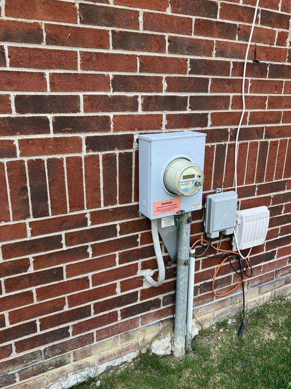 Completed new air conditioning system installation estimate for residence with no existing A/C unit. Assessed electrical infrastructure at exterior meter location on brick wall, including weatherproof meter enclosure, conduit routing, and secondary junction box with existing wiring connections. Evaluated interior thermostat location with Honeywell digital control currently managing emergency heat functions. Provided comprehensive estimate for complete outdoor condensing unit installation, including electrical requirements, proper placement considerations, and system specifications suitable for the property's configuration.