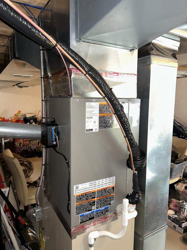 Successfully completed installation of a 3.5 ton air conditioning system with matching evaporator coil in residential basement location. Installed new air handler unit with proper refrigerant line connections on right side configuration, established condensate drainage via PVC piping, and completed electrical reconnection with appropriate disconnect and safety controls. All ductwork connections secured with proper sealing, system tested and verified operational, with mechanical, electrical, and air conditioning permits requested for code compliance.