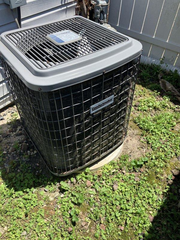 Provided comprehensive estimate for complete HVAC system replacement including 25-30 year old furnace currently located in laundry room and aging Comfortmaker air conditioning condenser unit. Assessed existing outdoor condenser installation showing vegetation encroachment around base, deteriorated brick paver pad with significant cracking and weed growth, and reviewed electrical conduit routing and service connections for replacement planning.