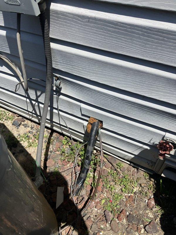 Provided comprehensive estimate for complete HVAC system replacement including 25-30 year old furnace currently located in laundry room and aging Comfortmaker air conditioning condenser unit. Assessed existing outdoor condenser installation showing vegetation encroachment around base, deteriorated brick paver pad with significant cracking and weed growth, and reviewed electrical conduit routing and service connections for replacement planning.