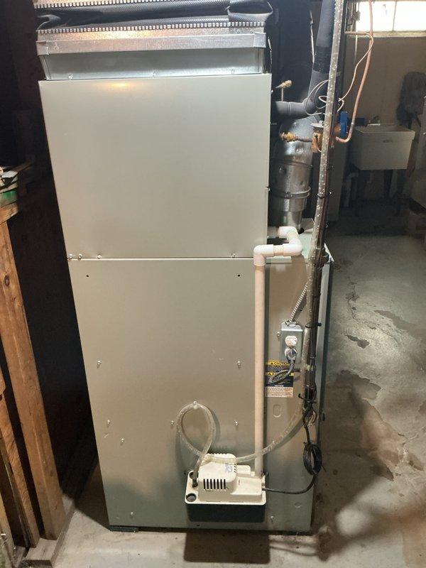 Responded to service call for central air conditioning system that was running but not producing cold air. Upon inspection, diagnosed locked compressor on outdoor condenser unit. Evaluated complete system including indoor air handler with condensate pump and determined compressor failure required full system replacement rather than repair. Provided comprehensive estimate for new HVAC system installation to restore cooling capability to residence.