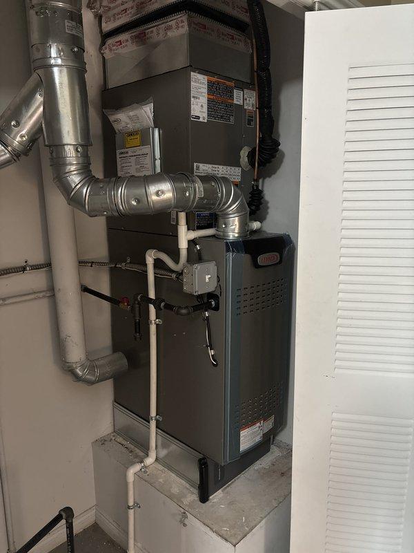 Completed full HVAC system installation including a 70,000 BTU furnace and 2.5 ton air conditioning unit with front discharge configuration. Installed new metallic ductwork with T-shaped configuration featuring tapered reducer fittings and secured all connections with metal band clamps. Ran white PVC condensate drainage piping, connected electrical conduit, and insulated ductwork with fiberglass insulation. Mounted furnace on concrete platform in utility closet, reconnected all existing utilities, and coordinated mechanical and electrical permit requirements. All components professionally installed with proper clearances, secure connections, and system tested for proper operation upon completion.