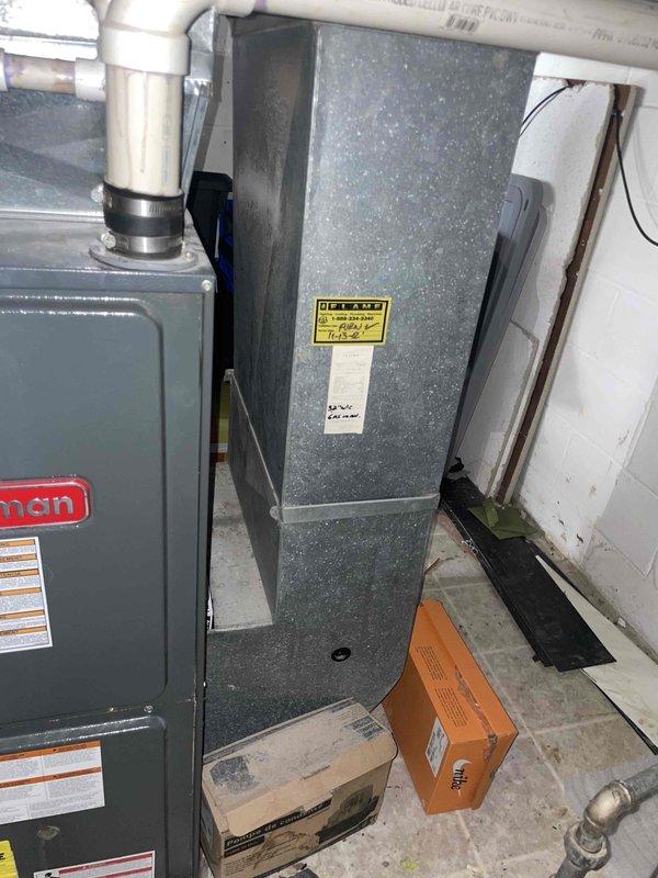 Responded to service call for 20+ year old R22 air conditioning system with improper operation. Upon inspection, found system completely empty of refrigerant, indicating total loss of charge due to age-related failure. Provided comprehensive estimate for complete HVAC system replacement including new air handler, condensing unit, and associated components. Documented existing basement installation with Goodman equipment, noting current ductwork configuration, PVC condensate drainage, and refrigerant line routing for replacement planning.