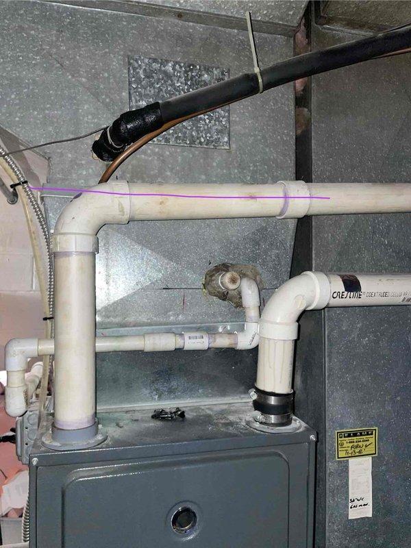Responded to service call for 20+ year old R22 air conditioning system with improper operation. Upon inspection, found system completely empty of refrigerant, indicating total loss of charge due to age-related failure. Provided comprehensive estimate for complete HVAC system replacement including new air handler, condensing unit, and associated components. Documented existing basement installation with Goodman equipment, noting current ductwork configuration, PVC condensate drainage, and refrigerant line routing for replacement planning.