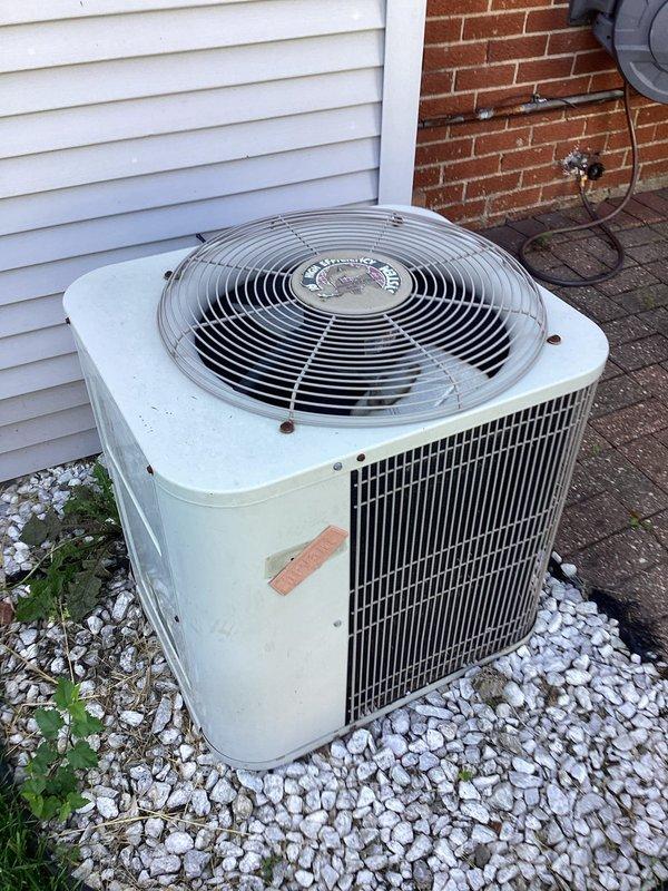 Completed estimate for replacement of aging outdoor air conditioning condenser unit and indoor HVAC equipment. Evaluated existing weathered AC unit positioned on gravel pad between vinyl siding and brick exterior, along with basement-mounted heating system connected to ductwork and PVC drainage lines. Provided comprehensive replacement options for complete residential HVAC system upgrade.