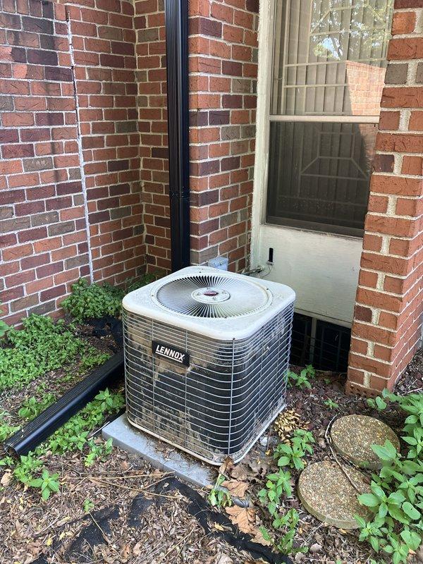 Responded to service call for 10-year-old Lennox air conditioning system that had stopped cooling properly. Upon inspection, diagnosed R22 refrigerant system with low charge. Verified thermostat operation showing current temperature of 77 degrees with setpoint at 73 degrees. Assessed outdoor condenser unit positioned against exterior brick wall and determined system age and refrigerant type made repair cost-prohibitive. Provided estimate for complete HVAC system replacement due to obsolete R22 refrigerant, system age, and declining efficiency.