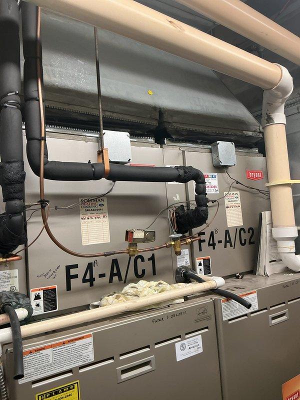 Completed installation of 2-ton air conditioning system with new evaporator coil in mechanical room. Installed two Bryant HVAC units (F4-A/C-1 and F4-A/C-2) with complete refrigerant line connections, condensate drainage system with pump, and electrical reconnections. All PVC piping, copper tubing, and insulation properly installed per code requirements. Mechanical, electrical, and AC permits obtained and work inspected. System tested and operational upon completion.