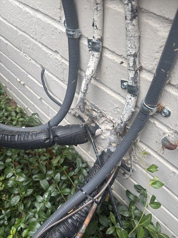 Replaced deteriorated SER cables running from the electrical disconnect to the main panel due to severely compromised insulation with exposed bare conductors in multiple locations. New cables were properly installed and secured using appropriate conduit and mounting hardware to ensure code compliance and safe operation of the electrical system.