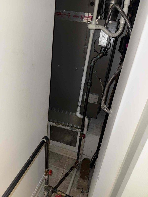 Responded to recall for ongoing condensate leak on 2-year-old AC unit located in utility room with mold and mildew growth present on equipment. Inspected air handler, condensate drain system, and evaporator coil assembly. Found condensate drain line improperly pitched causing water backup and accumulation on unit cabinet. Cleared primary drain line, verified proper drainage flow, and treated drain pan with antimicrobial solution to address existing mold growth. Recommended monitoring system over next cooling cycle to ensure leak is fully resolved and advised on preventive maintenance to avoid future microbial contamination.
